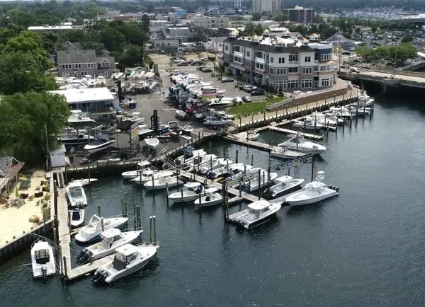 Slide: The Image of Aerial view of marina with NorthCoast 255 Cabin boats, 2024 model, docked. - 33