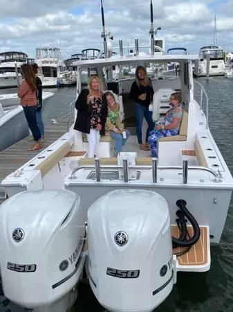 Slide: The Image of 2024 NorthCoast 255 Cabin boat with Yamaha 250 engines docked, people onboard. - 35