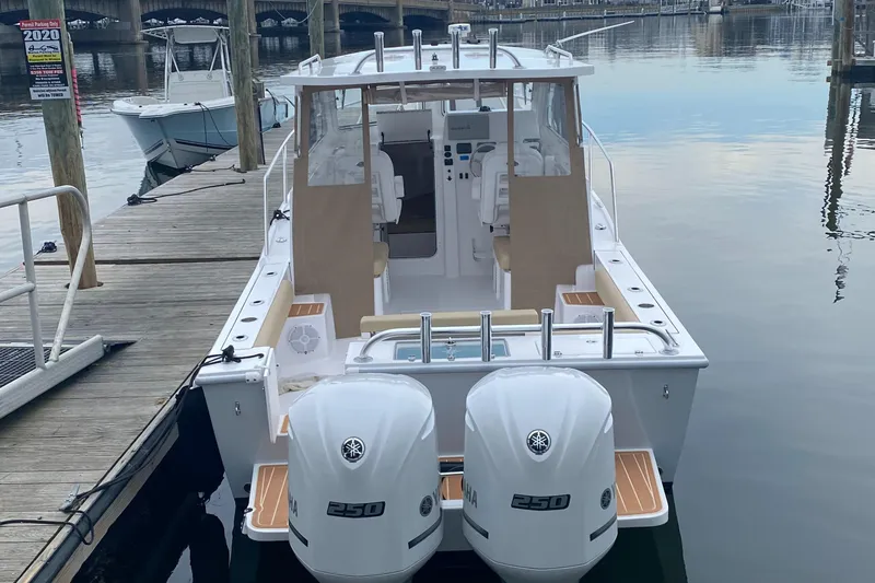 Slide: The Image of 2024 NorthCoast 255 Cabin boat docked with twin Yamaha 250 engines. - 36