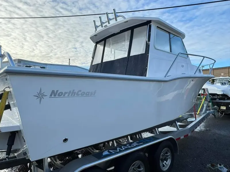 Slide: The Image of 2024 NorthCoast 255 Cabin boat on trailer, side view. - 9