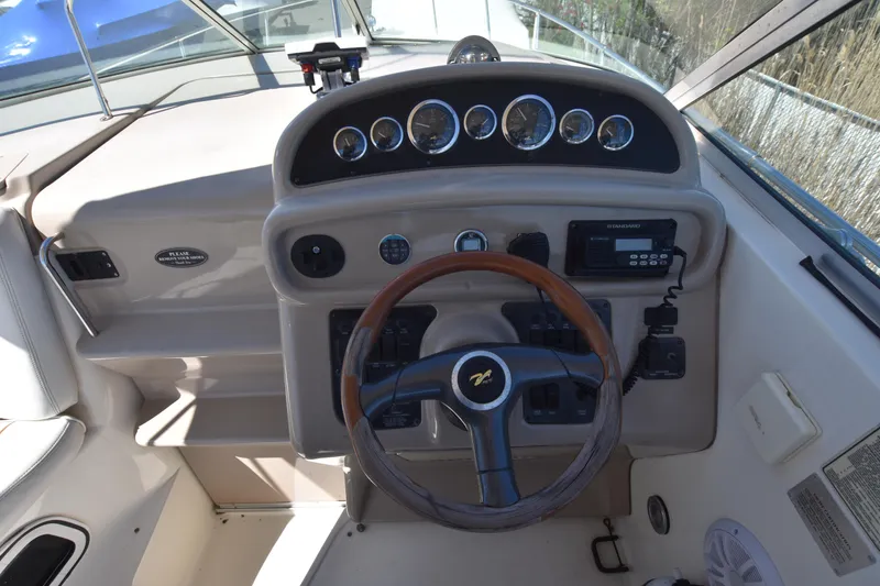 Slide: The Image of 1998 Sea Ray 270 Sundancer boat helm with steering wheel and instrument panel. - 11