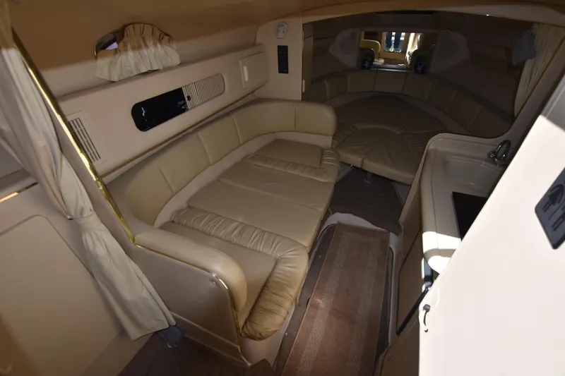 Slide: The Image of Interior cabin of a 1998 Sea Ray 270 Sundancer boat with beige seating. - 13