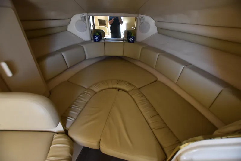 Slide: The Image of 1998 Sea Ray 270 Sundancer cabin interior with beige upholstery. - 14