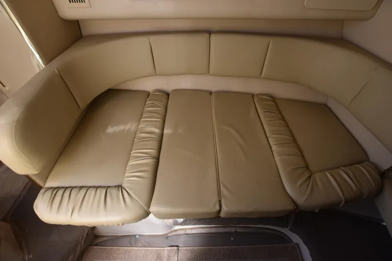 Slide: The Image of 1998 Sea Ray 270 Sundancer interior seating area with beige leather upholstery. - 15