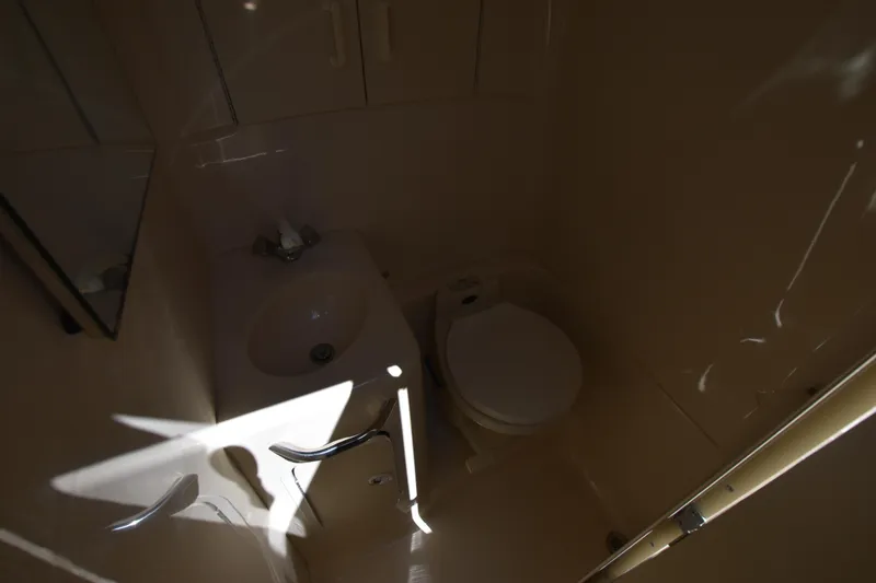 Slide: The Image of 1998 Sea Ray 270 Sundancer bathroom with sink and toilet. - 19