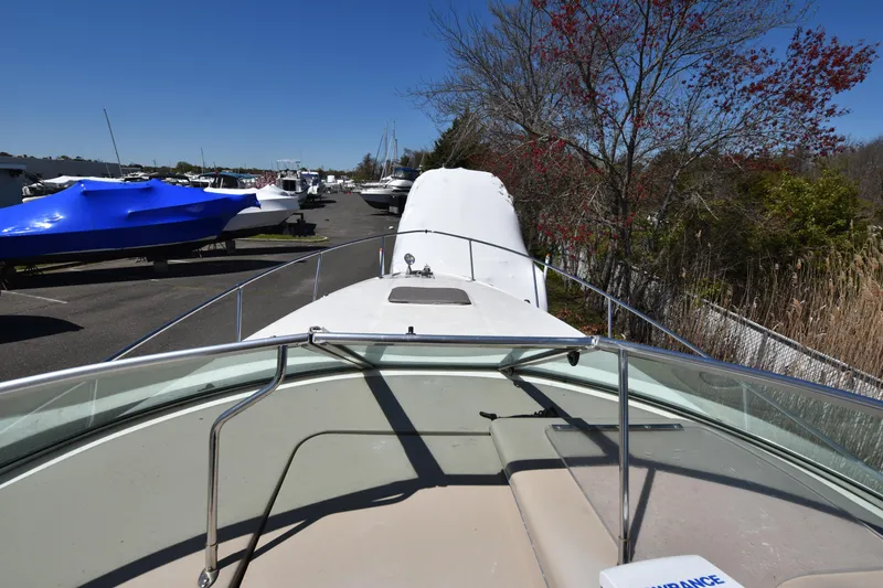 Slide: The Image of 1998 Sea Ray 270 Sundancer boat on a trailer in a marina. - 21