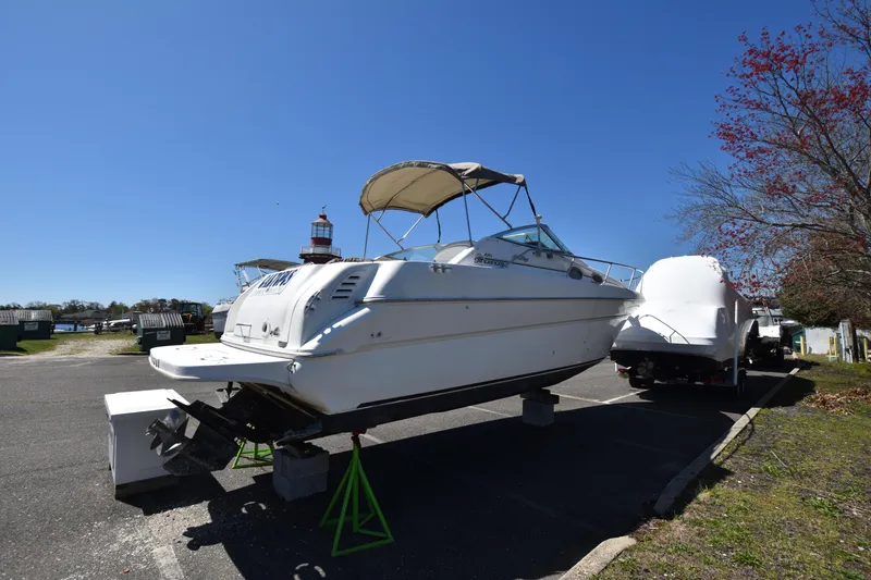Slide: The Image of 1998 Sea Ray 270 Sundancer boat on stands in a marina parking lot. - 3
