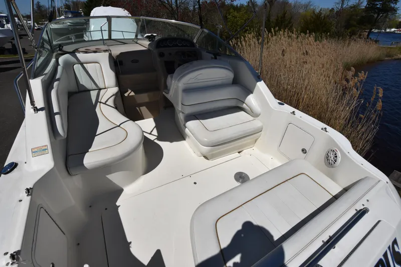 Slide: The Image of 1998 Sea Ray 270 Sundancer boat interior with white seating and dashboard. - 5