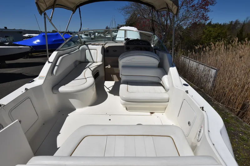 Slide: The Image of 1998 Sea Ray 270 Sundancer boat interior with white seating and canopy. - 6