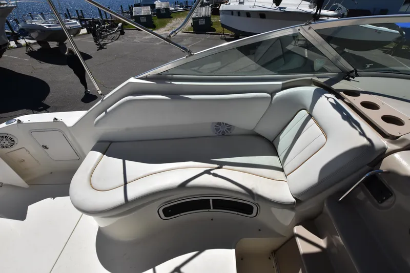 Slide: The Image of 1998 Sea Ray 270 Sundancer boat interior with white seating and cup holders. - 8