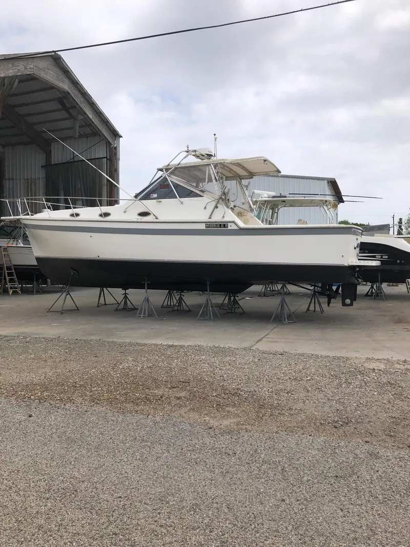 The Image of 1987 Luhrs Alura boat on stands in a boatyard. - 0