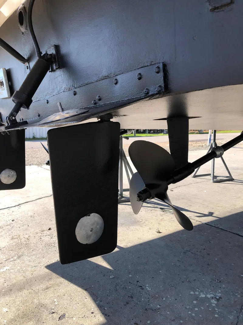 Slide: The Image of 1987 Luhrs Alura boat propeller and rudder system on dry dock. - 6