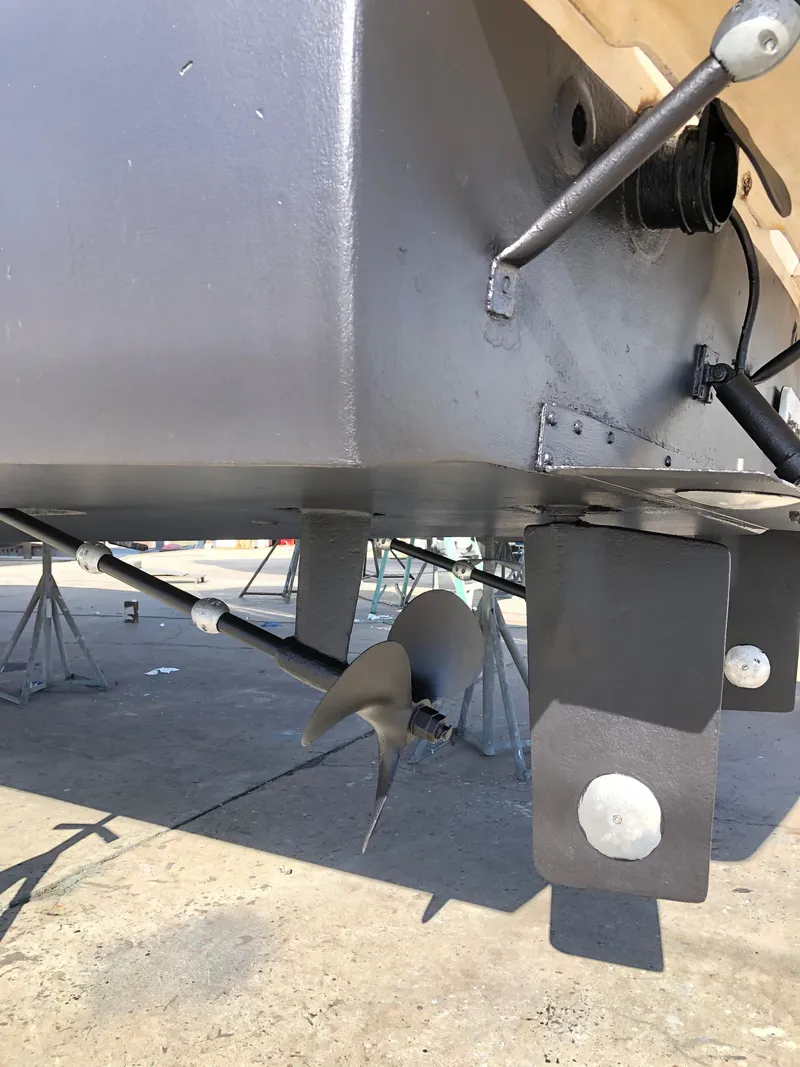 Slide: The Image of 1987 Luhrs Alura boat propeller and rudder system on dry dock. - 7