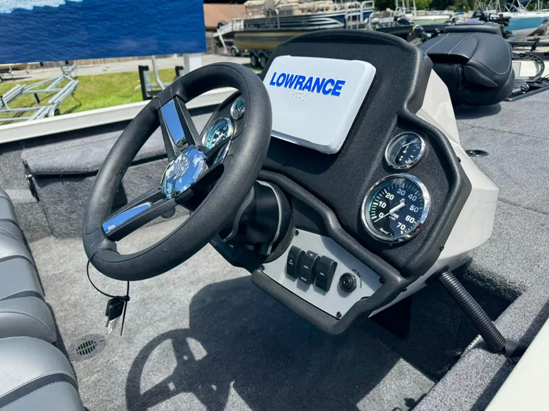 Slide: The Image of 2024 Ranger RT178 boat dashboard with Lowrance electronics and steering wheel. - 2