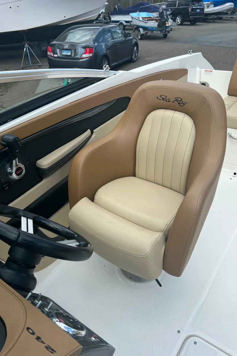 Slide: The Image of 2014 Sea Ray 240 Sundeck Outboard captain's chair and helm station. - 10