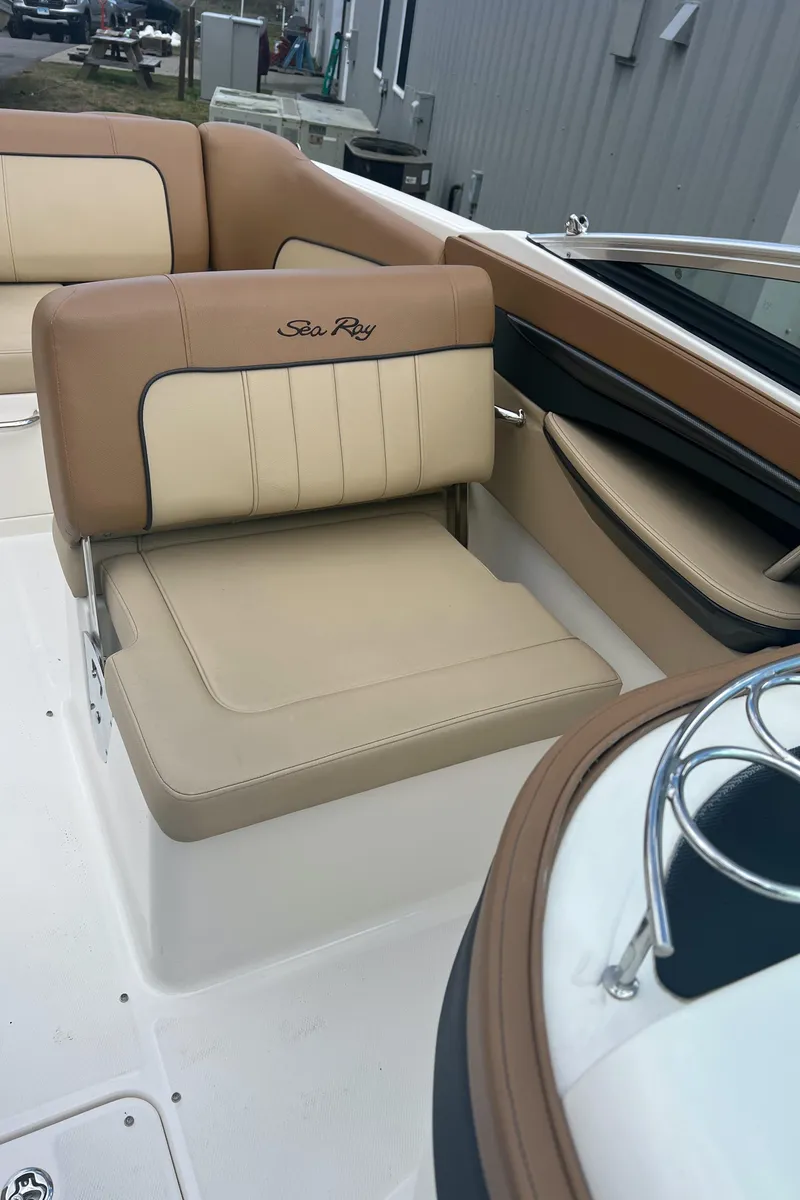 Slide: The Image of 2014 Sea Ray 240 Sundeck Outboard boat interior with tan and beige seating. - 11