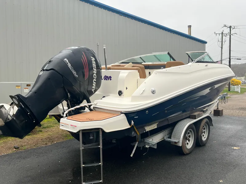 Slide: The Image of 2014 Sea Ray 240 Sundeck Outboard on trailer, featuring a powerful Mercury engine. - 5