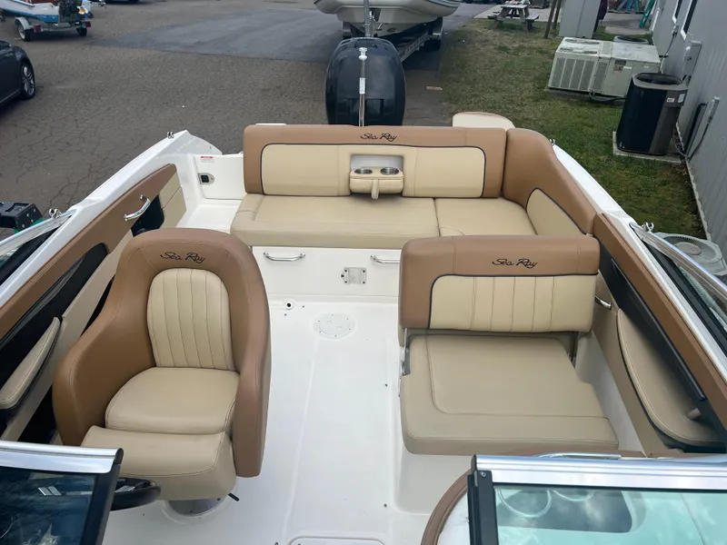 Slide: The Image of 2014 Sea Ray 240 Sundeck Outboard boat interior with beige seating. - 7