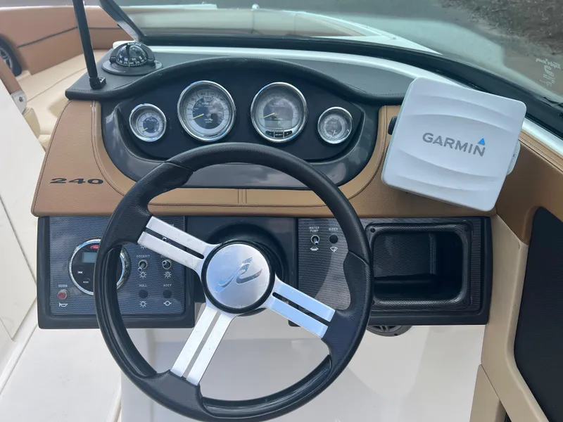Slide: The Image of 2014 Sea Ray 240 Sundeck Outboard dashboard with Garmin navigation system. - 9