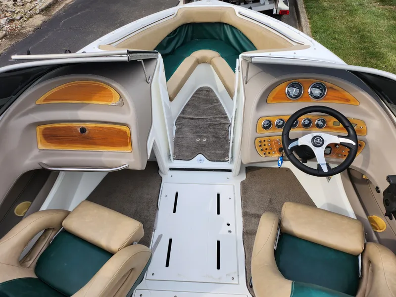 Slide: The Image of Interior of a 1998 Cobalt 200 boat with beige and green seating. - 11