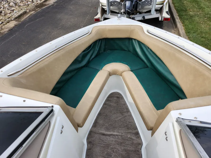 Slide: The Image of Interior of a 1998 Cobalt 200 boat with green and beige seating. - 15