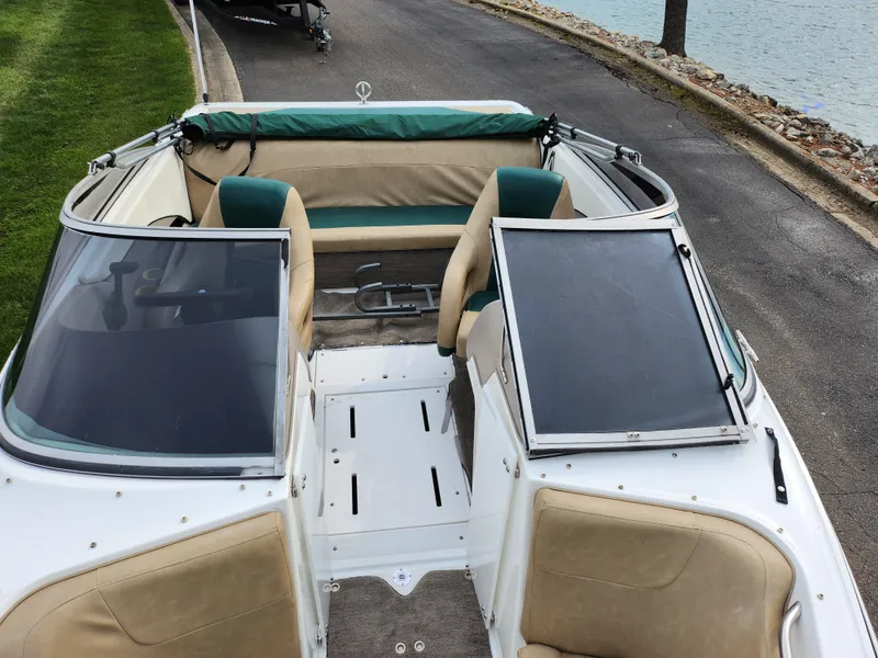 Slide: The Image of 1998 Cobalt 200 boat interior with beige and green seating. - 17
