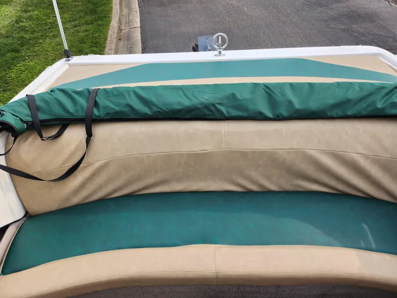 Slide: The Image of 1998 Cobalt 200 boat with green and beige seating. - 19