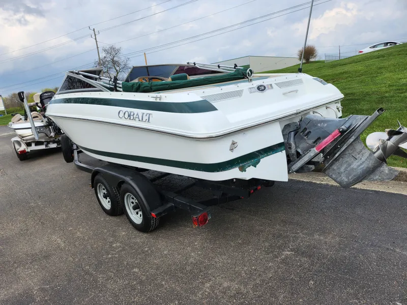 Slide: The Image of 1998 Cobalt 200 boat on a trailer, white with green accents. - 3