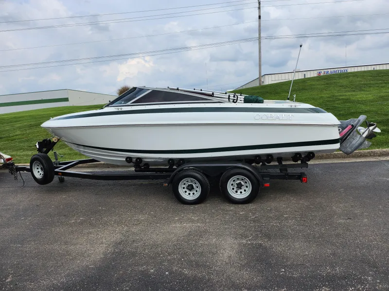 Slide: The Image of 1998 Cobalt 200 boat on a trailer, white with green accents. - 4