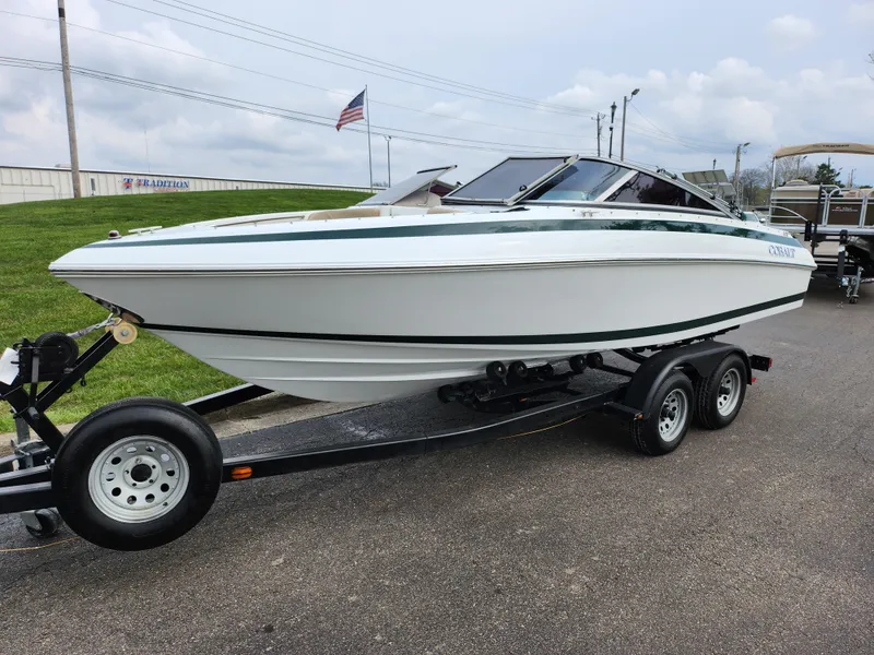 Slide: The Image of 1998 Cobalt 200 boat on a trailer, white hull with green trim. - 5