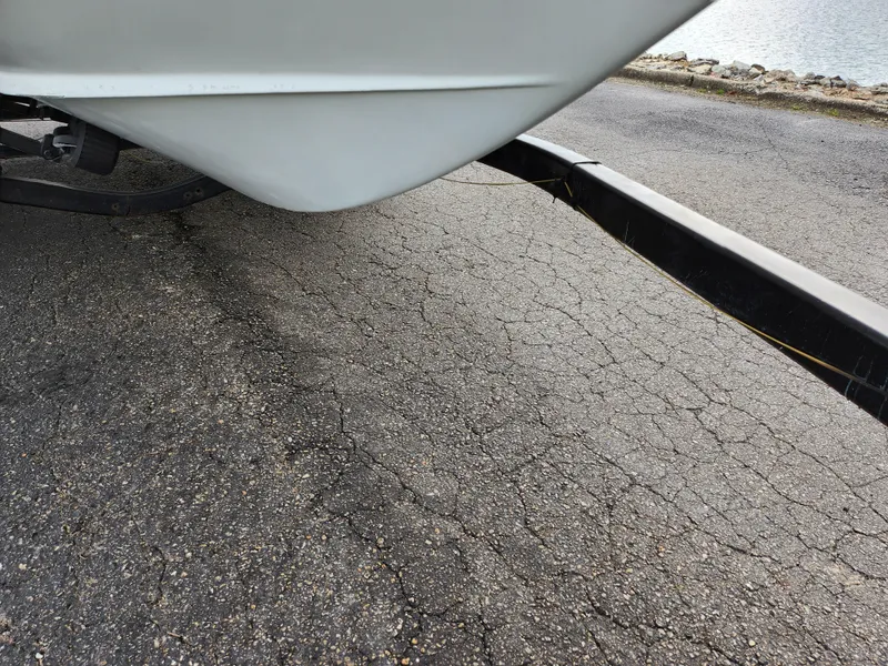 Slide: The Image of Close-up of a 1998 Cobalt 200 boat on a trailer near a waterfront. - 7