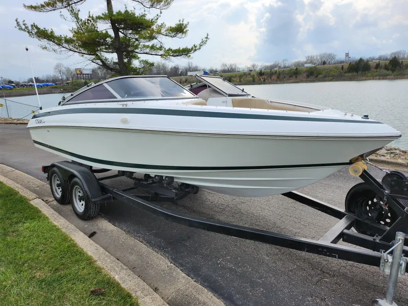 Slide: The Image of 1998 Cobalt 200 boat on a trailer by a lakeside. - 8
