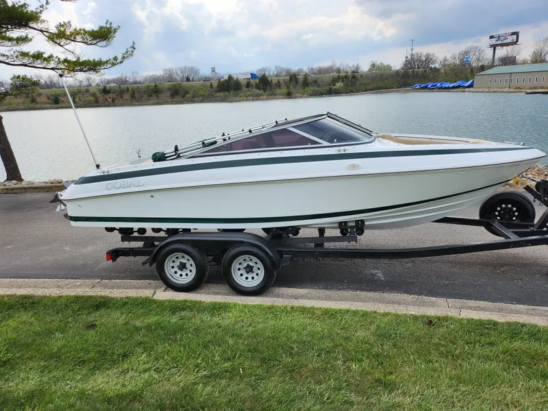 Slide: The Image of 1998 Cobalt 200 boat on trailer by a lake. - 9