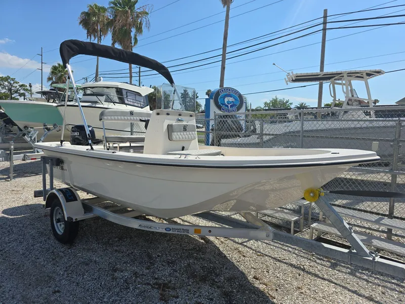 Slide: The Image of 2024 Carolina Skiff E16 JVX CC boat on trailer, displayed outdoors. - 0