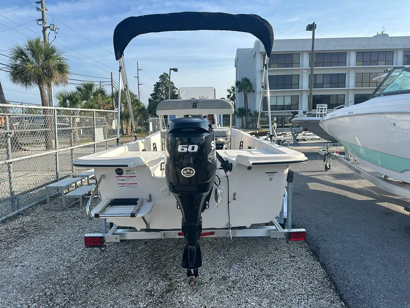 Slide: The Image of 2024 Carolina Skiff E16 JVX CC boat with 60 HP engine, parked outdoors. - 11