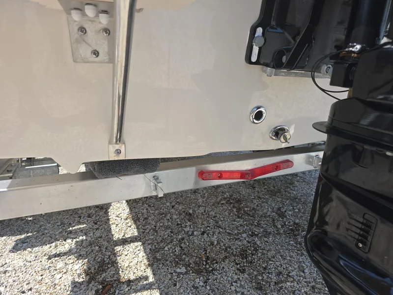 Slide: The Image of Close-up of the 2024 Carolina Skiff E16 JVX CC boat's rear hull and trailer. - 15