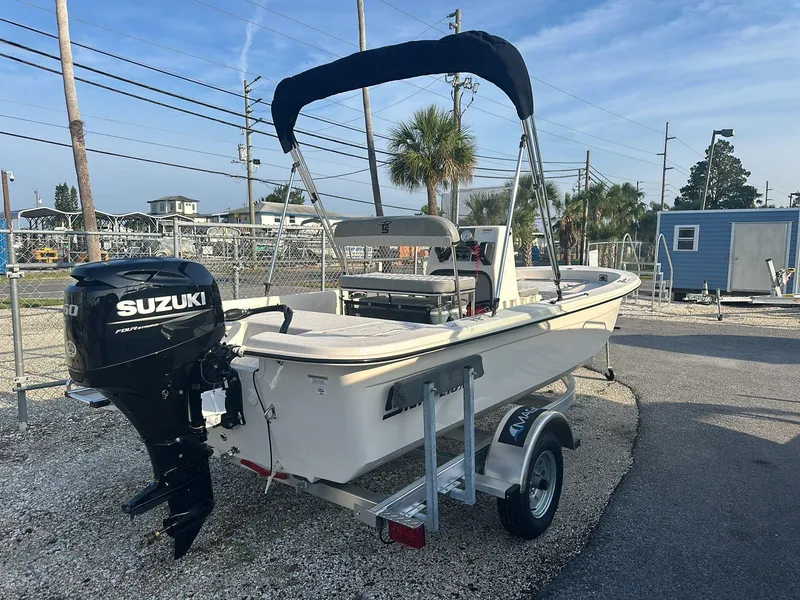 Slide: The Image of 2024 Carolina Skiff E16 JVX CC boat with Suzuki outboard motor on trailer. - 3