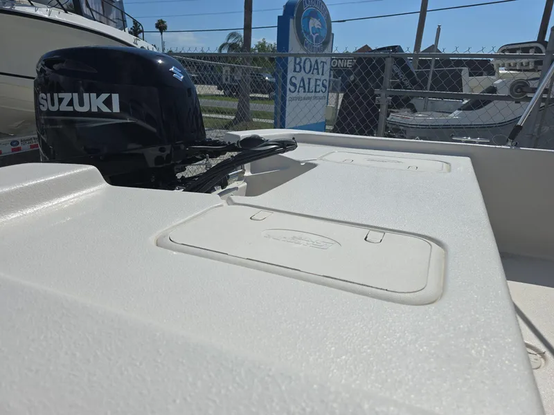 Slide: The Image of 2024 Carolina Skiff E16 JVX CC with Suzuki outboard motor at boat sales lot. - 5