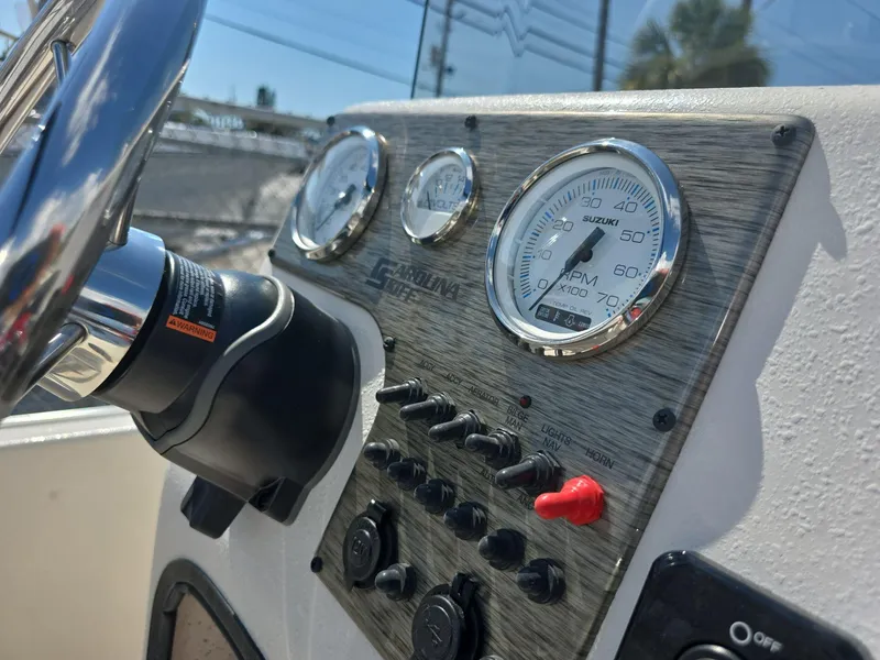 Slide: The Image of Close-up of 2024 Carolina Skiff E16 JVX CC boat dashboard and controls. - 9