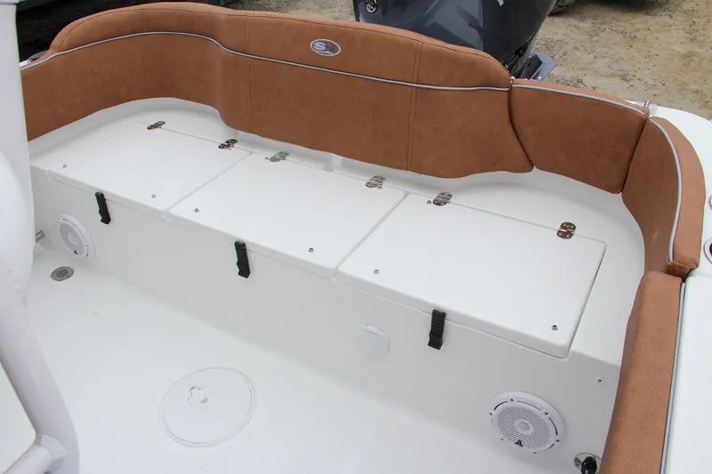 Slide: The Image of 2024 Sea Hunt Ultra 229 boat with cushioned seating and storage compartments. - 10