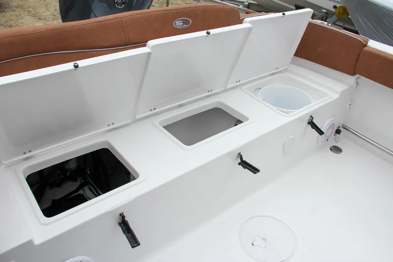 Slide: The Image of 2024 Sea Hunt Ultra 229 boat storage compartments and seating area. - 11