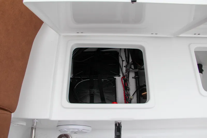 Slide: The Image of Open storage compartment on a 2024 Sea Hunt Ultra 229 boat. - 12