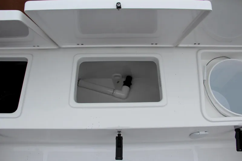 Slide: The Image of 2024 Sea Hunt Ultra 229 storage compartments and livewell. - 13