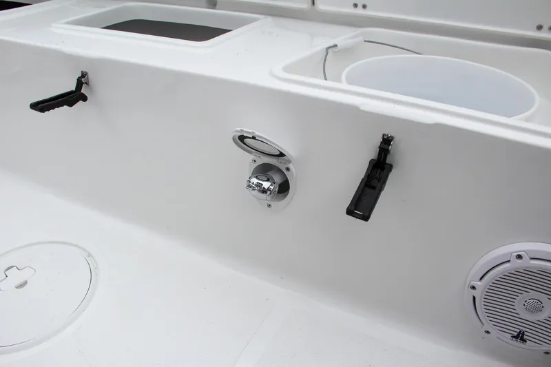 Slide: The Image of 2024 Sea Hunt Ultra 229 boat interior with storage compartments and fishing rod holders. - 15