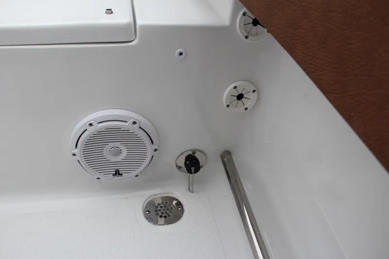 Slide: The Image of 2024 Sea Hunt Ultra 229 boat interior with speaker and drainage system. - 16