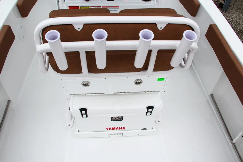 Slide: The Image of 2024 Sea Hunt Ultra 229 boat interior with rod holders and Yamaha cooler. - 17
