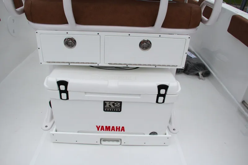 Slide: The Image of 2024 Sea Hunt Ultra 229 boat interior with Yamaha cooler and storage drawers. - 18