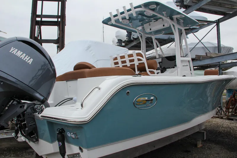 Slide: The Image of 2024 Sea Hunt Ultra 229 boat with Yamaha engine in storage. - 2