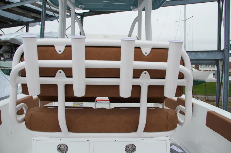 Slide: The Image of 2024 Sea Hunt Ultra 229 boat with rod holders and cushioned seating. - 21