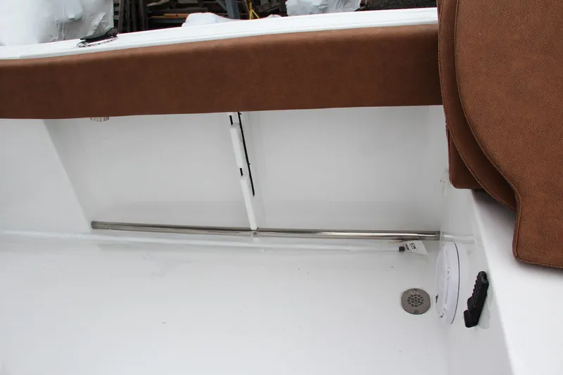 Slide: The Image of 2024 Sea Hunt Ultra 229 boat interior detail with brown seating and white deck. - 24